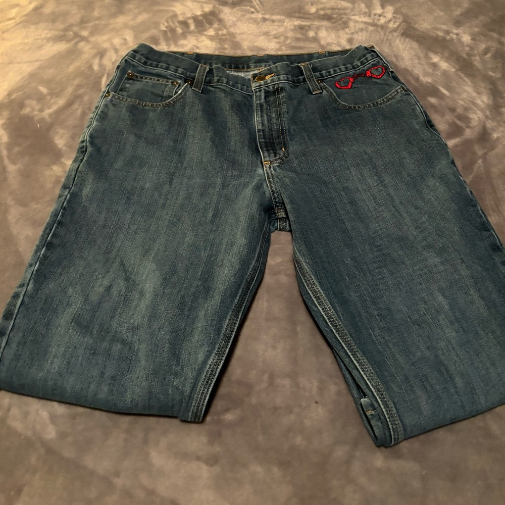 Mens carhartt jeans with hand embroidered red heart handcuffs on the pocket